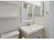 Bathroom with sink, mirror and floating shelves at 4006 Markham Pl, Orlando, FL 32814