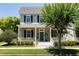 Two-story house with gray siding, black shutters, and a teal front door at 4006 Markham Pl, Orlando, FL 32814