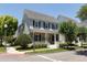 Two-story house with gray siding, black shutters, and a teal front door at 4006 Markham Pl, Orlando, FL 32814