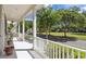 White porch with white railings overlooking a grassy park-like area at 4006 Markham Pl, Orlando, FL 32814