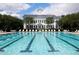 Community lap pool with a classic clubhouse in the background at 4006 Markham Pl, Orlando, FL 32814