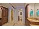 Bathroom featuring tile floors, a marble double sink vanity, and a glass enclosed shower at 4175 S Atlantic Ave # 232, New Smyrna Beach, FL 32169
