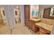 Spacious bathroom featuring tile floors, a double sink with marble counters, and a glass enclosed shower at 4175 S Atlantic Ave # 232, New Smyrna Beach, FL 32169