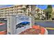 Condominium exterior view showcasing the building and signage, complemented by mature landscaping at 4175 S Atlantic Ave # 232, New Smyrna Beach, FL 32169