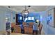 Open concept dining room with a view of the living room, stylish lighting and decor at 4175 S Atlantic Ave # 232, New Smyrna Beach, FL 32169