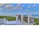 An outdoor grilling area with multiple stainless steel grills and seating, ideal for seaside cookouts at 4175 S Atlantic Ave # 232, New Smyrna Beach, FL 32169