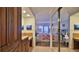 Hallway view of a spacious bedroom featuring wood laminate floors and shuttered doors to the balcony at 4175 S Atlantic Ave # 232, New Smyrna Beach, FL 32169