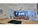 Open concept dining room with a view of the living room, stylish lighting and decor at 4175 S Atlantic Ave # 232, New Smyrna Beach, FL 32169
