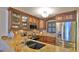 Kitchen featuring custom wood cabinets, stainless steel appliances, and tile backsplash at 4175 S Atlantic Ave # 232, New Smyrna Beach, FL 32169