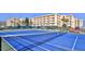 A well-maintained tennis court with a net, benches, and surrounding landscaping for a fun outdoor activity at 4175 S Atlantic Ave # 232, New Smyrna Beach, FL 32169