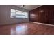 Bright bedroom with wood-look floors and wood paneling at 421 Sw 23Rd St, Ocala, FL 34471