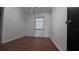 Simple bedroom with wood flooring and a window with blinds at 421 Sw 23Rd St, Ocala, FL 34471
