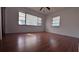 Well-lit bedroom with laminate wood flooring and two windows at 421 Sw 23Rd St, Ocala, FL 34471