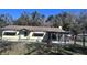 House with chain link fence and mature trees at 421 Sw 23Rd St, Ocala, FL 34471