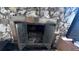 Classic stone fireplace with metal surround and glass doors at 421 Sw 23Rd St, Ocala, FL 34471