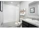 Well-lit bathroom featuring a tub with shower, modern fixtures, and stylish neutral-toned decor at 514 Eagle Landing Blvd, Winter Haven, FL 33880