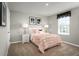 Charming bedroom featuring soft pink accents, cozy carpeting, and plenty of natural light at 514 Eagle Landing Blvd, Winter Haven, FL 33880