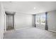 Large bedroom with plush carpet, natural light, and access to a walk-in closet at 514 Eagle Landing Blvd, Winter Haven, FL 33880