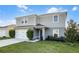 Charming two-story home with a two car garage and manicured lawn on a sunny day at 514 Eagle Landing Blvd, Winter Haven, FL 33880