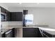 Kitchen featuring modern appliances, dark cabinets, and stone countertops at 514 Eagle Landing Blvd, Winter Haven, FL 33880