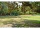 Large grassy yard, mature trees, and built-in fire pit at 632 Tildenville School Rd, Winter Garden, FL 34787