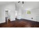 Unfurnished bedroom features hardwood floors, a ceiling fan, and a door to the bathroom at 632 Tildenville School Rd, Winter Garden, FL 34787