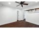 Simple bedroom with dark wood floors, white walls, a ceiling fan, and ample closet space at 632 Tildenville School Rd, Winter Garden, FL 34787