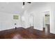 Unfurnished bedroom with hardwood floors, a ceiling fan, and access to the bathroom at 632 Tildenville School Rd, Winter Garden, FL 34787