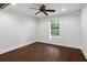 Bright bedroom featuring hardwood floors and a ceiling fan at 632 Tildenville School Rd, Winter Garden, FL 34787