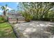 Two-story home features a backyard gravel area, a small deck, and is shaded by mature trees at 632 Tildenville School Rd, Winter Garden, FL 34787