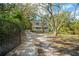 Long driveway leads to the charming two-story home with a welcoming front porch, set amongst mature trees at 632 Tildenville School Rd, Winter Garden, FL 34787