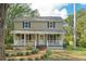 Charming two-story home featuring a welcoming front porch, lush landscaping, and a classic design at 632 Tildenville School Rd, Winter Garden, FL 34787