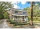 Charming two-story home with a welcoming front porch, lush landscaping, and a tranquil setting at 632 Tildenville School Rd, Winter Garden, FL 34787