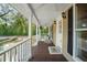 Inviting front porch with rocking chairs, ceiling fans, and classic design details for relaxing outdoor living at 632 Tildenville School Rd, Winter Garden, FL 34787