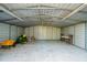 Metal garage featuring workbench, yellow yard cart and John Deere riding mower at 632 Tildenville School Rd, Winter Garden, FL 34787