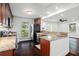 Stylish kitchen with granite countertops, wood cabinets, stainless steel appliances, and dark wood floors at 632 Tildenville School Rd, Winter Garden, FL 34787