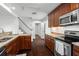 Updated kitchen with granite countertops, wood cabinets, stainless steel appliances, and dark wood floors at 632 Tildenville School Rd, Winter Garden, FL 34787