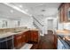Spacious kitchen featuring granite countertops, wood cabinetry, stainless steel appliances, and access to the staircase at 632 Tildenville School Rd, Winter Garden, FL 34787