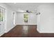 Bright living room with dark wood floors, white walls, a ceiling fan and natural light from multiple windows at 632 Tildenville School Rd, Winter Garden, FL 34787