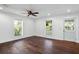 Living room with hardwood floors, windows with blinds, and a white door at 632 Tildenville School Rd, Winter Garden, FL 34787