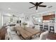 Open-concept living room with white couches, dining area, and bar seating to the kitchen at 632 Tildenville School Rd, Winter Garden, FL 34787