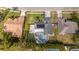 Aerial view featuring a home with a pool, backyard fire pit, solar panels, and landscaping at 637 W Artesia St, Oviedo, FL 32765