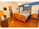Bright bedroom features a wooden bed frame, matching nightstands, and blue accent wall at 742 Seneca Meadows Rd, Winter Springs, FL 32708