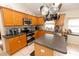 Well-equipped kitchen with stainless steel appliances, wooden cabinets and center island with bar stools at 742 Seneca Meadows Rd, Winter Springs, FL 32708