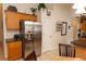 Spacious kitchen featuring a stainless steel refrigerator, wooden cabinets, and an adjacent dining area at 742 Seneca Meadows Rd, Winter Springs, FL 32708