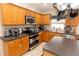 Fully equipped kitchen featuring stainless steel appliances, plenty of counter space, and wooden cabinetry at 742 Seneca Meadows Rd, Winter Springs, FL 32708