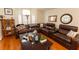 Cozy living room with a comfortable leather sectional sofa, and lots of pillows at 742 Seneca Meadows Rd, Winter Springs, FL 32708