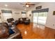 Cozy living room showcasing a ceiling fan, valance window treatments, and sliding glass doors at 742 Seneca Meadows Rd, Winter Springs, FL 32708