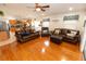 Inviting living room with hardwood floors and stylish, comfortable leather furniture at 742 Seneca Meadows Rd, Winter Springs, FL 32708