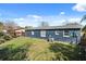 Home's blue exterior with a grassy backyard, and an AC unit on the side at 783 Cornelia Ct, Orlando, FL 32811